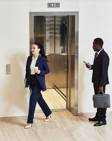 Coworkers using elevator