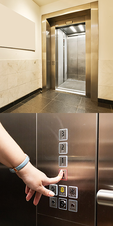 Gold Ionic elevator and woman pushing button